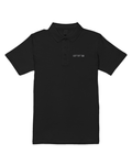 black pique polo with a small light-grey NOT YET 00 line on the chest, flat view on white