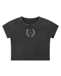 snow-washed black crop tee with a small cream laurel crest reading NYB on the chest, flat view on white