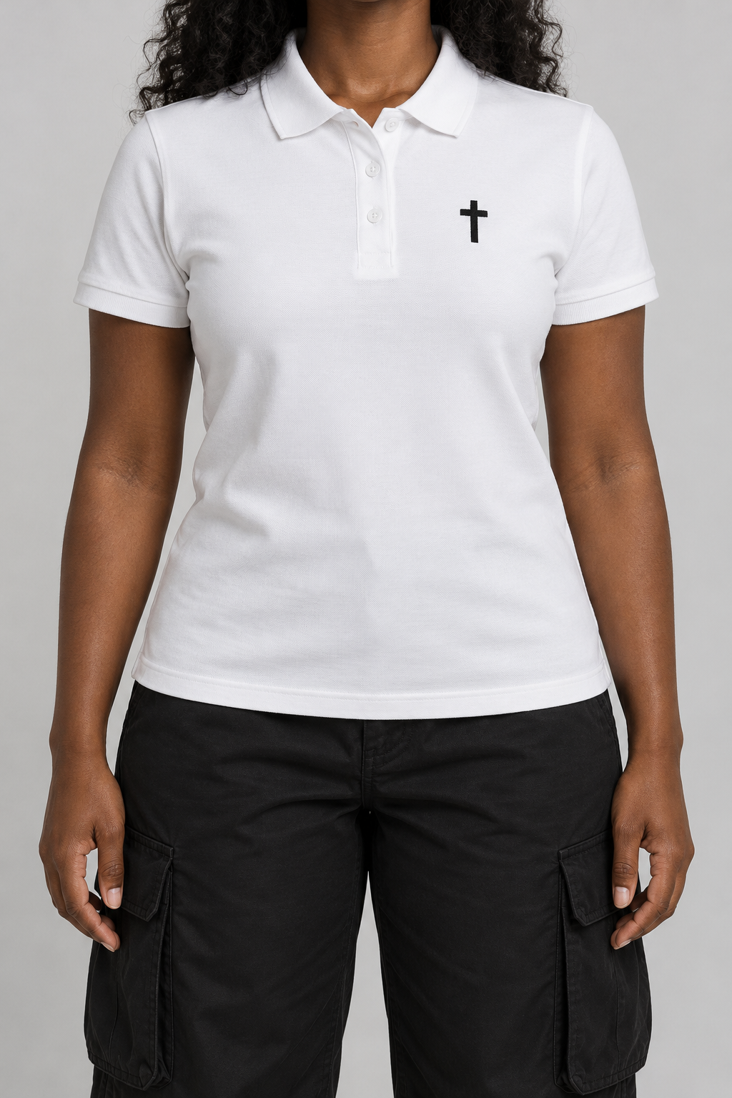 white pique polo with a small black embroidered cross on the chest, on model, front view from the collarbone down
