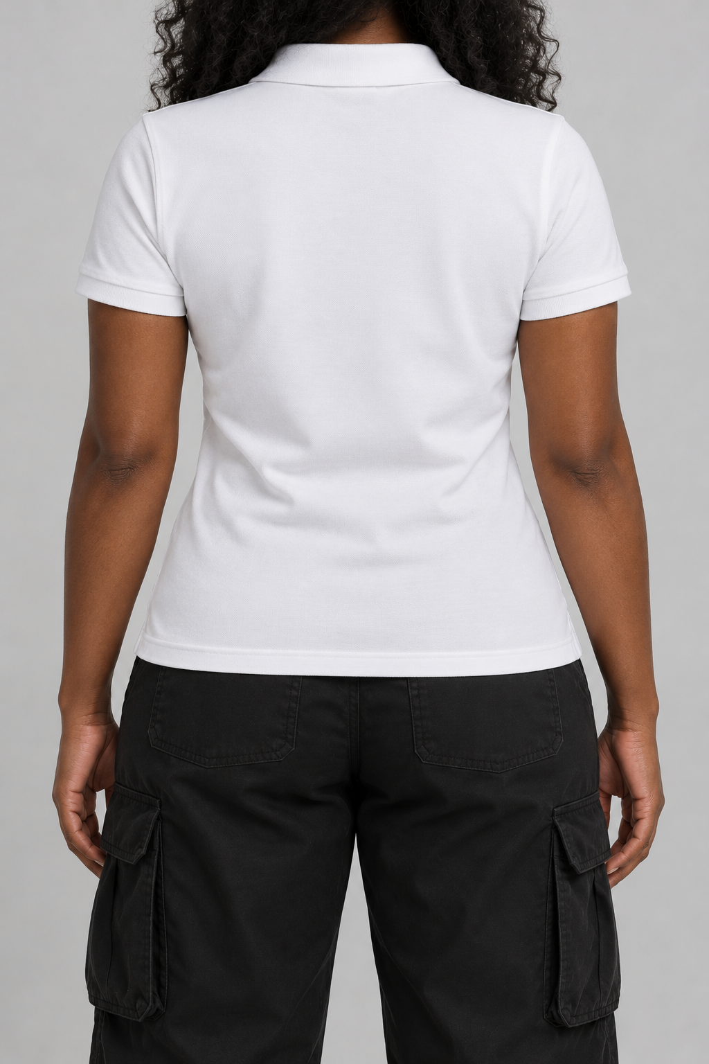 white pique polo with a small black embroidered cross on the chest, on model, back view