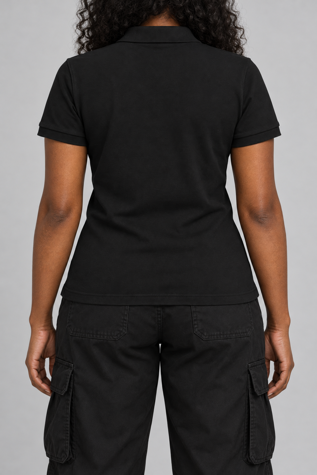 black pique polo with a small light-grey NOT YET 00 line on the chest, on model, back view