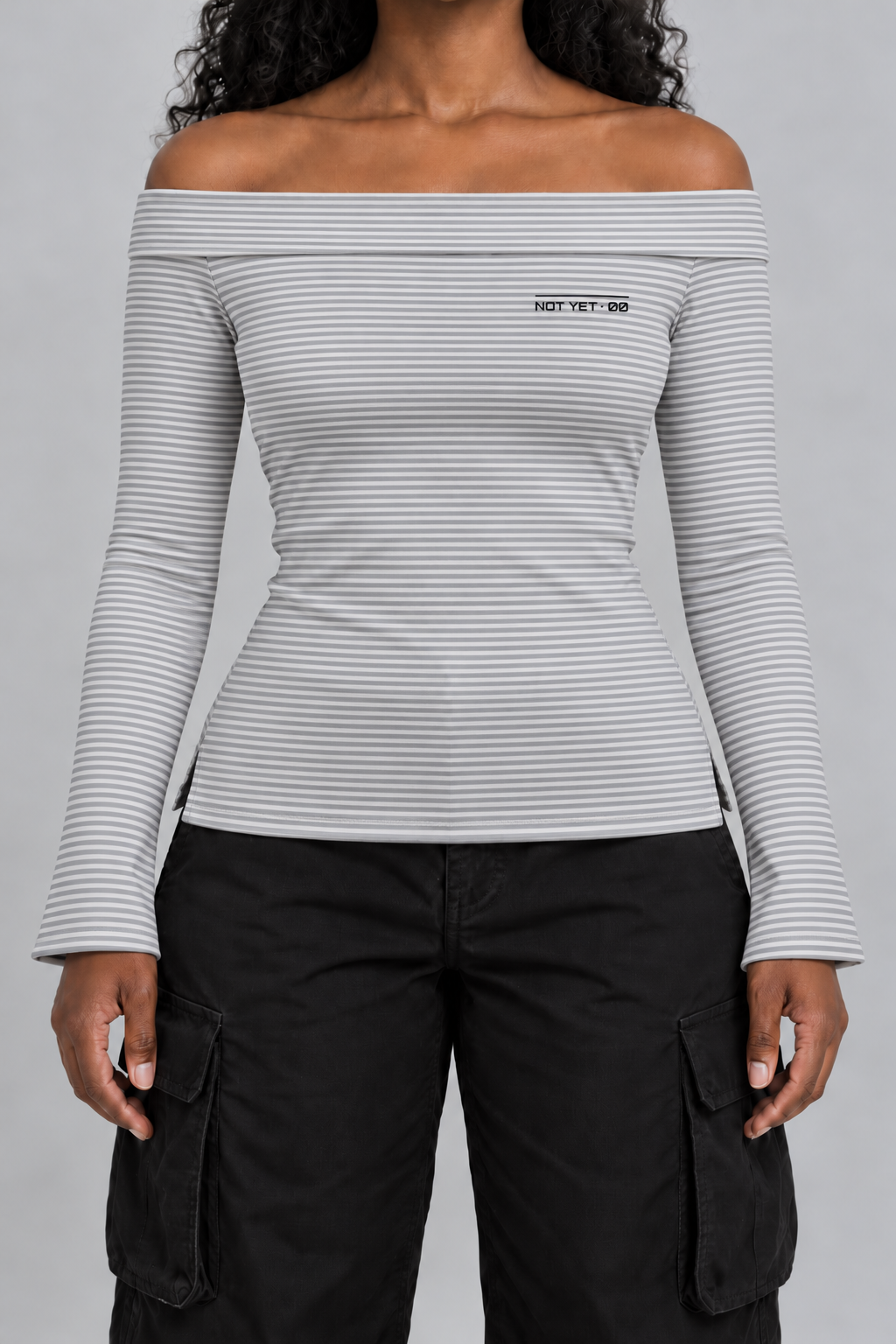 fitted off-shoulder long sleeve top in fine grey and white stripes with a tiny NOT YET 00 line on the chest, on model, front view from the collarbone down