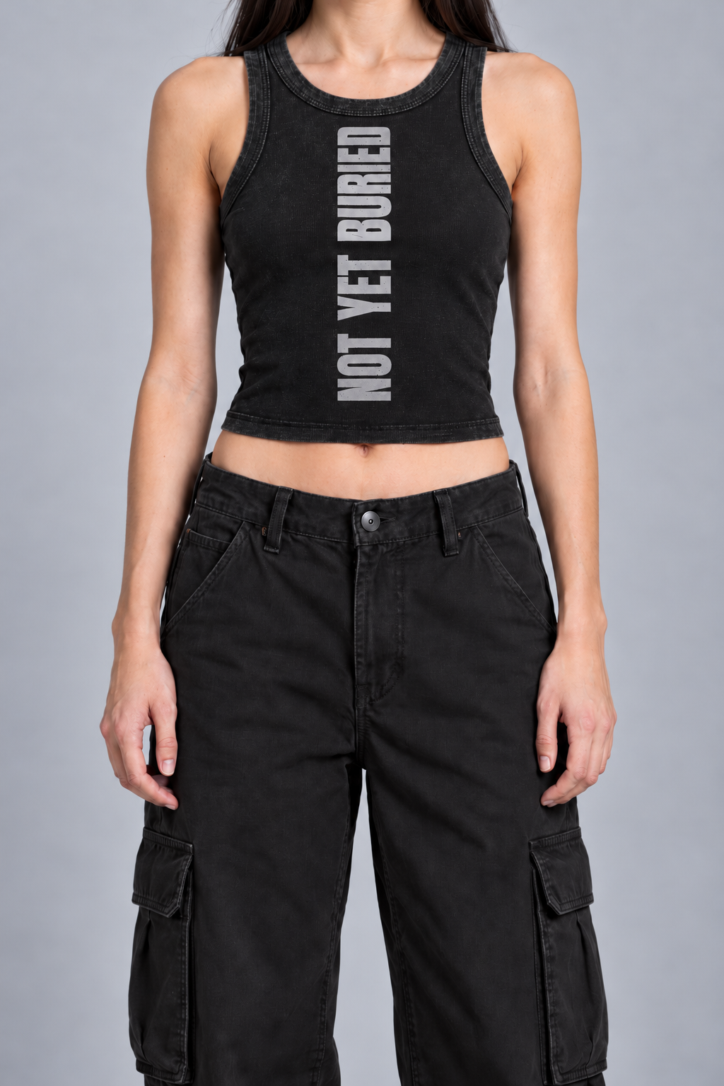 snow-washed black tank with NOT YET BURIED in tall silver-grey letters running up the front, on model, front view from the collarbone down