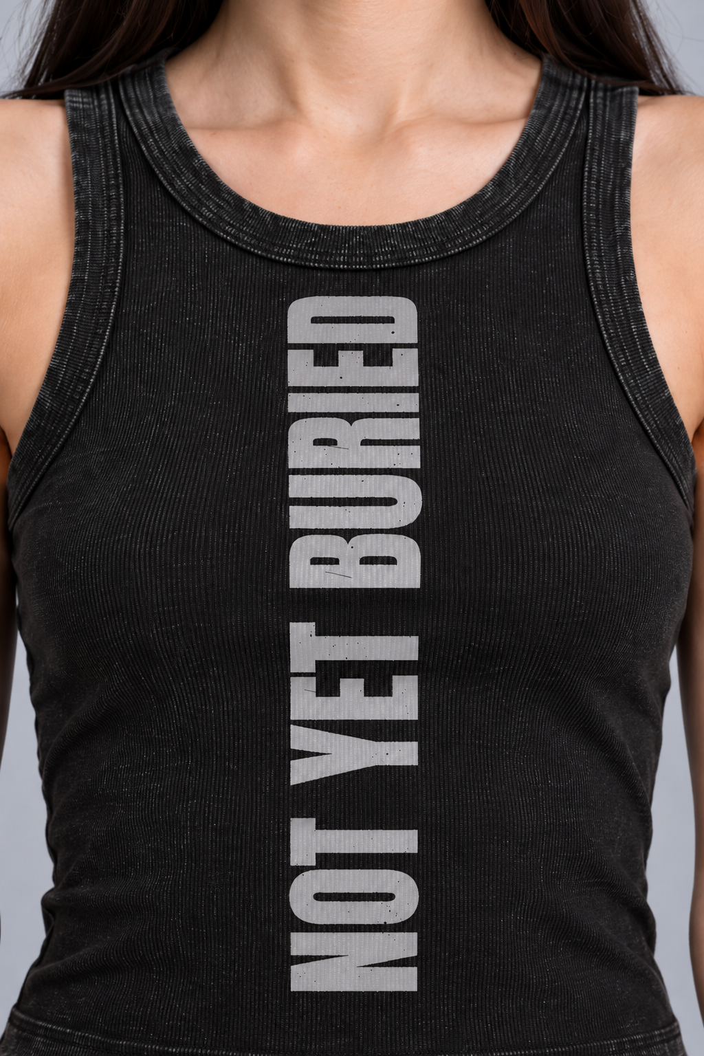 snow-washed black tank with NOT YET BURIED in tall silver-grey letters running up the front, close-up of the tall silver-grey NOT YET BURIED lettering
