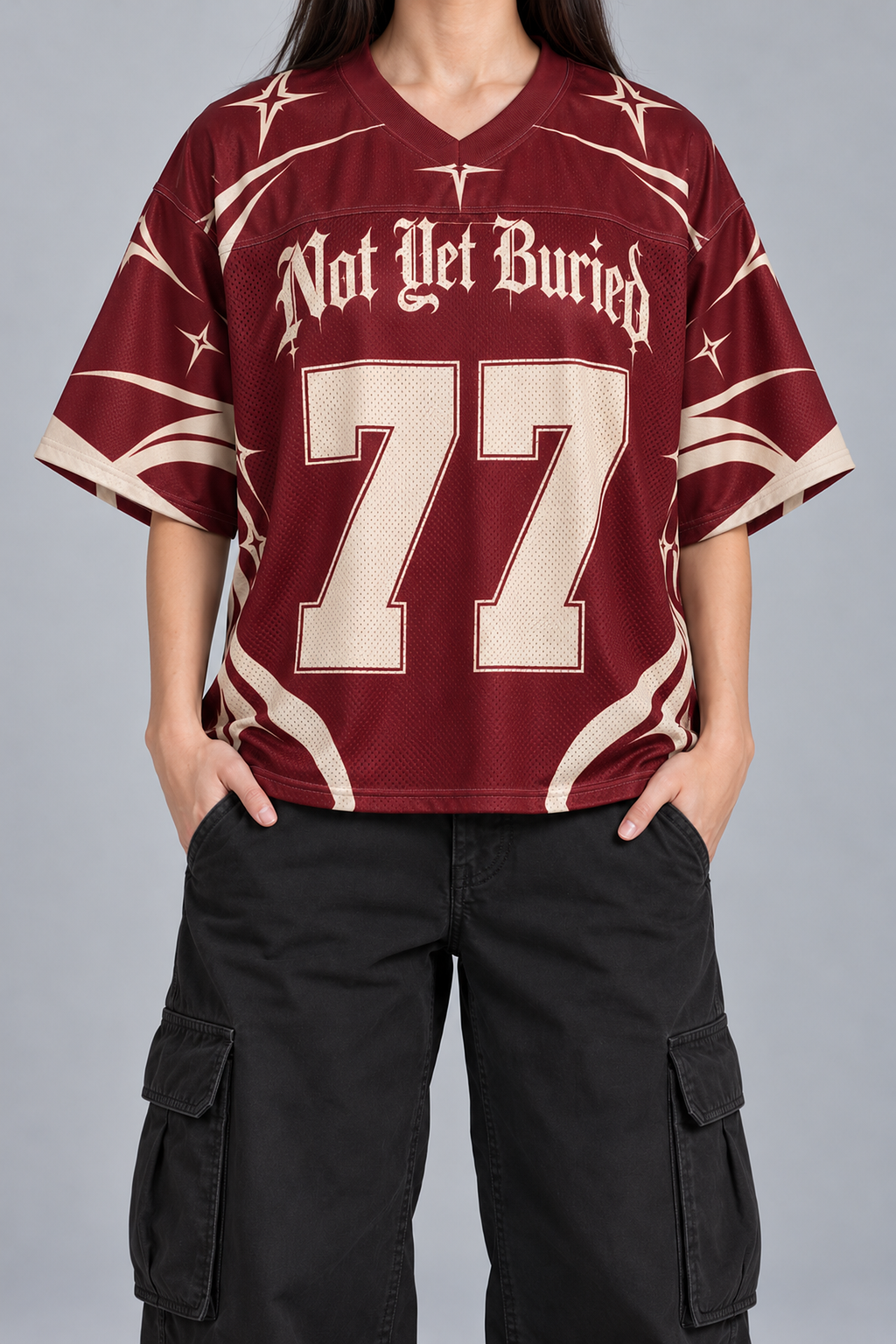"CRIMSON BONE" burgundy and cream football jersey, worn, front view, hands in pockets
