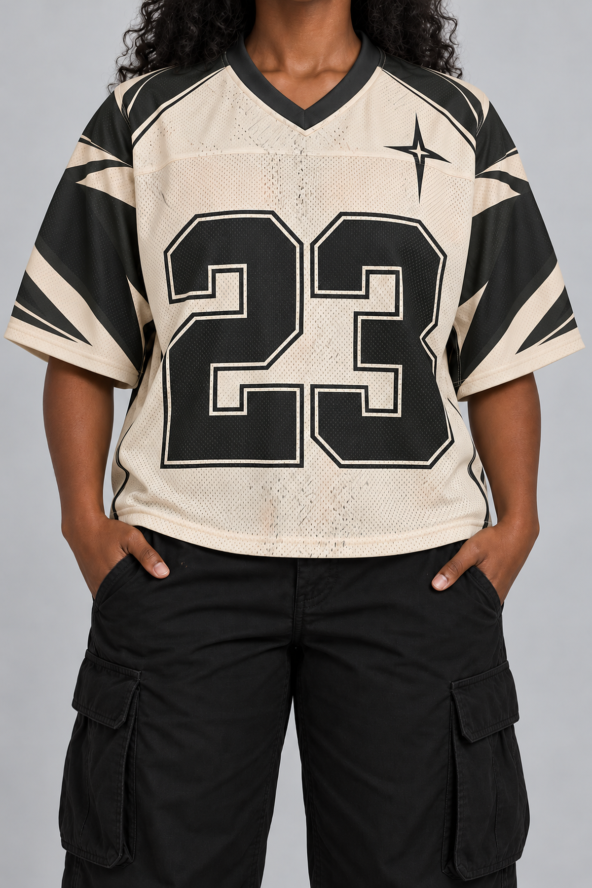 "ST VINCE" cream and black football jersey, worn, front view, hands in pockets